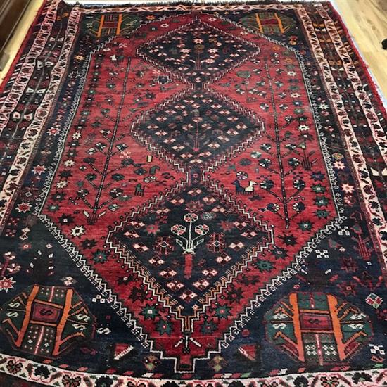 A Persian red ground rug 265cm x 205cm